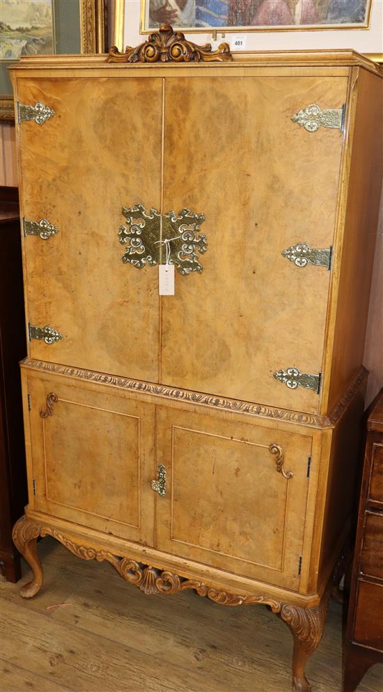 A 1950s burr walnut cocktail cabinet W.89cm